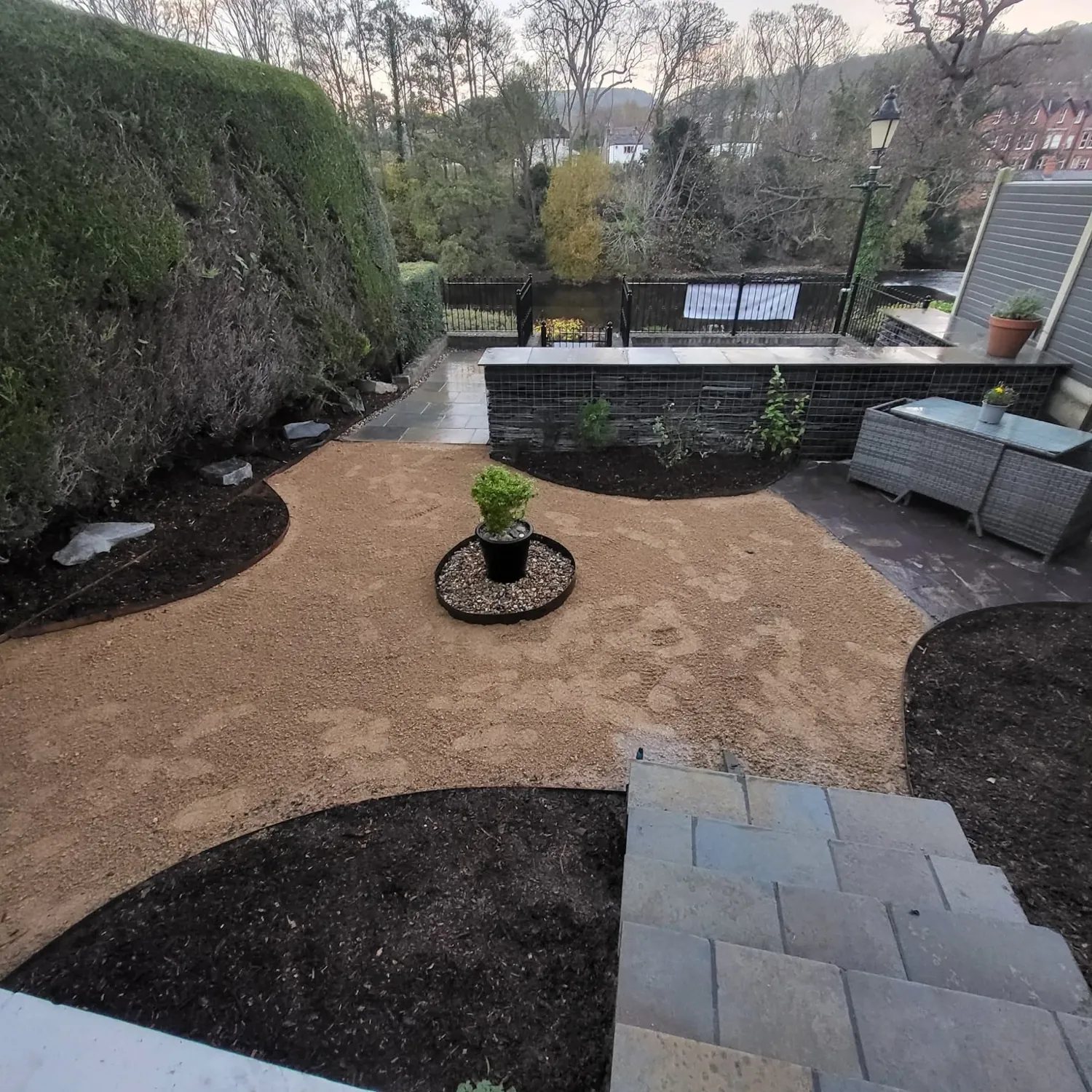 Curved gravel garden and planting beds